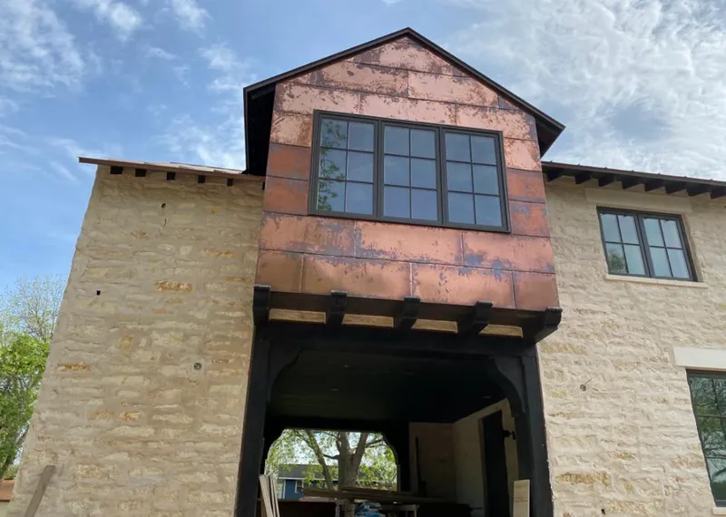 Copper metal panel facade on a stone building for Skylight Installation in Bessemer